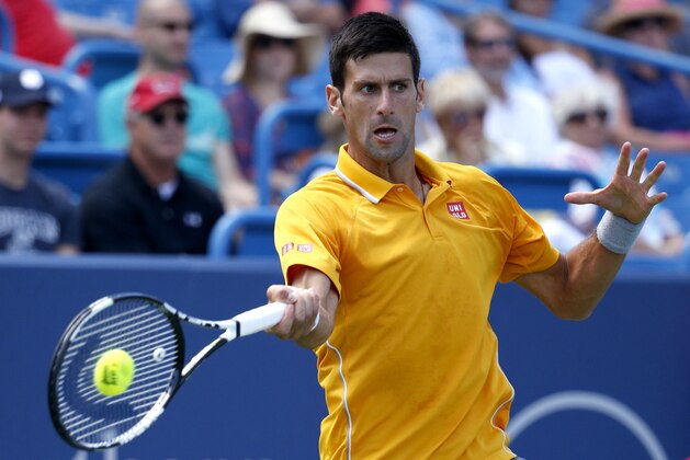 Novak Djokovic, of Serbia, returns the ball to David Goffin, of Belgium, during a match at the Western & Southern Open tennis tournament, Thursday, Aug. 20, 2015, in Mason, Ohio. (AP Photo/John Minchillo)