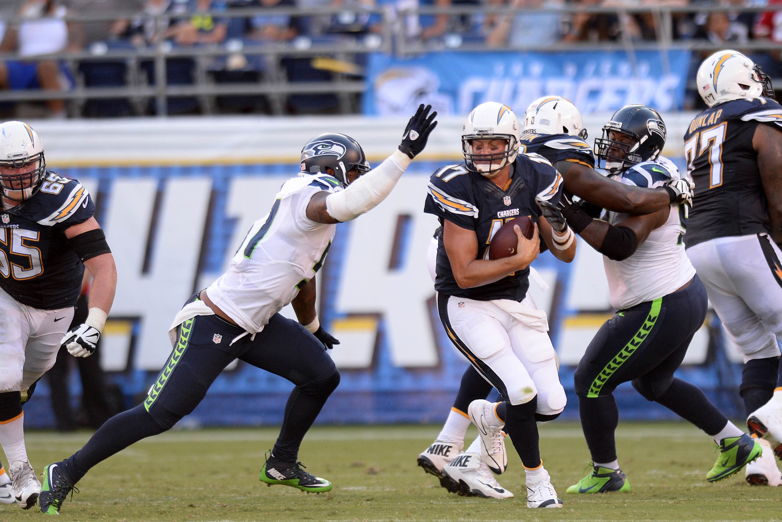 Aug 29, 2015; San Diego, CA, USA; San Diego Chargers quarterback Philip Rivers (17) is pressured by Seattle Seahawks outside linebacker Bruce Irvin (51) during the second quarter at Qualcomm Stadium. Mandatory Credit: Jake Roth-USA TODAY Sports