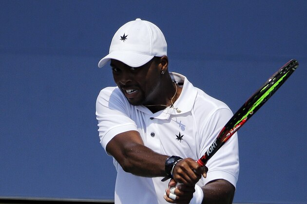 Donald Young, of the United States, returns a shot to Gilles Simon, of France, during the first round of the U.S. Open tennis tournament, Tuesday, Sept. 1, 2015, in New York. (AP Photo/Frank Franklin II)