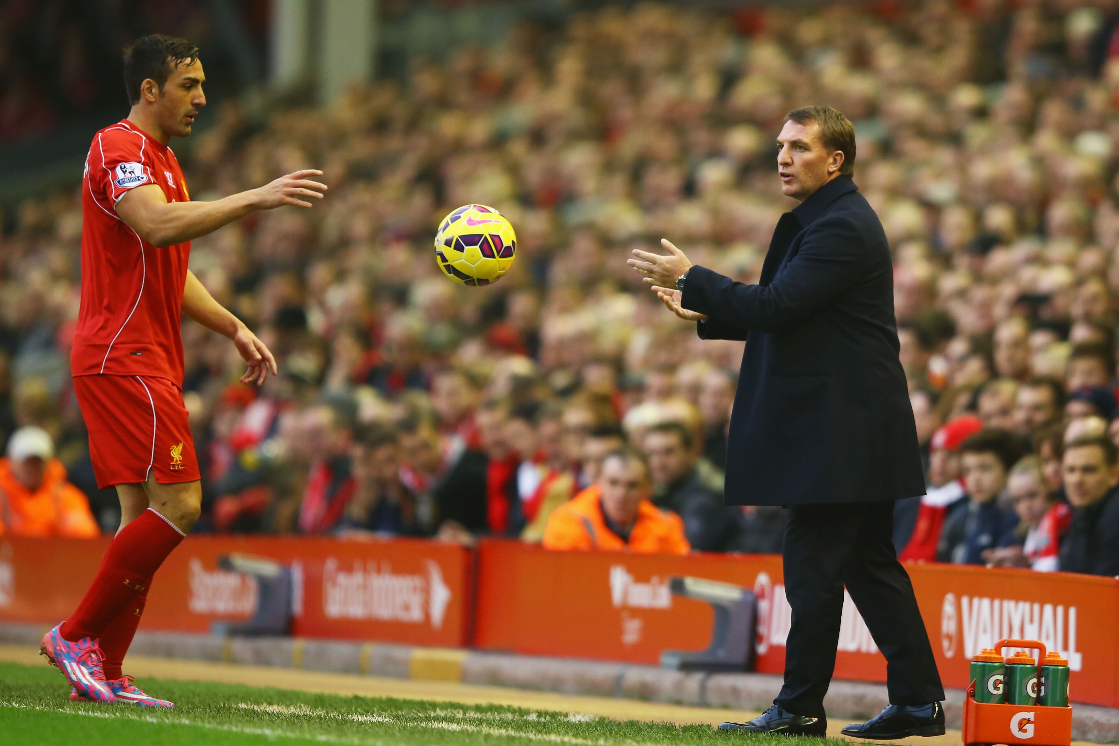 LIVERPOOL, ENGLAND - NOVEMBER 29:  Brendan Rodgers manager of Liverpool throws the ball to Jose Enrique of Liverpool during the Barclays Premier League match between Liverpool and Stoke City at Anfield on November 29, 2014 in Liverpool, England.  (Photo by Richard Heathcote/Getty Images)