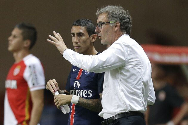 PSG player Angel Di Maria speaks with the coach of PSG, Laurent Blanc, before taking to the pitch during the French League One soccer match against Monaco, in Monaco stadium, Sunday, Aug. 30, 2015. (AP Photo/Lionel Cironneau)