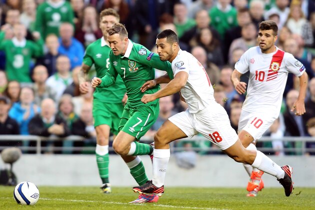 Republic of Ireland's Aiden McGeady (2nd L) vies for the ball with Gibraltar's Yogan Santos (2nd R) during a UEFA 2016 European Championship qualifing football match between the Republic of Ireland and Gibraltar at the Aviva Stadium in Dublin, Ireland on October 11, 2014.  AFP PHOTO / PAUL FAITH        (Photo credit should read PAUL FAITH/AFP/Getty Images)