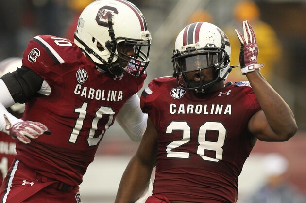 Dec 27, 2014; Shreveport, LA, USA; South Carolina Gamecocks linebacker Skai Moore (10) and linebacker Jonathan Walton (28) celebrate after an interception by Walton in the second quarter against the Miami Hurricanes in the 2014 Independence Bowl at Independence Stadium. Mandatory Credit: Nelson Chenault-USA TODAY Sports