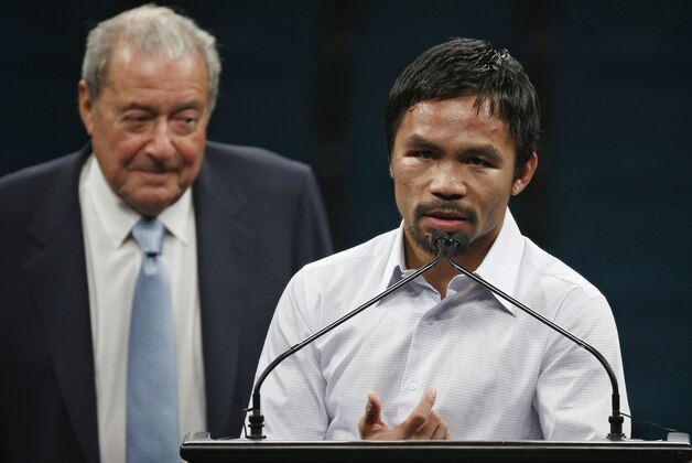 Promoter Bob Arum, left, watches as Manny Pacquiao answers reporter questions during a press conference following his welterweight title fight on Saturday, May 2, 2015 in Las Vegas. Floyd Mayweather defeated Pacquiao in a unanimous decision. (AP Photo/John Locher)