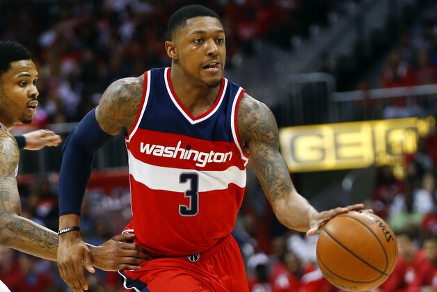 Washington Wizards guard Bradley Beal (3) drives past Atlanta Hawks guard Kent Bazemore (24) in the second half of an NBA second-round basketball payoff series game, Sunday, May 3, 2015, in Atlanta. Washington won 104-98. (AP Photo/John Bazemore)