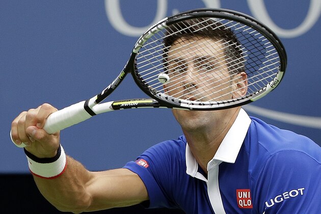 Novak Djokovic, of Serbia, returns a shot to Joao Souza, of Brazil, during the first round of the U.S. Open tennis tournament, Monday, Aug. 31, 2015, in New York. (AP Photo/Matt Rourke)