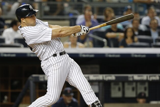 New York Yankees' Mark Teixeira swings on a sixth-inning single that scored Chris Young in a baseball game against the Boston Red Sox at Yankee Stadium in New York, Tuesday, Aug. 4, 2015. (AP Photo/Kathy Willens)