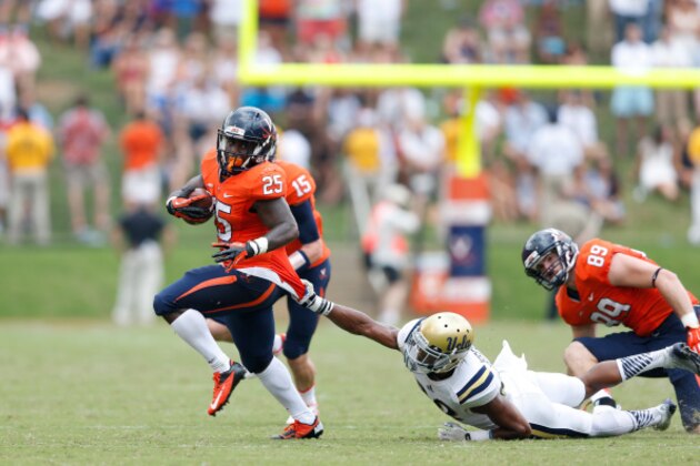 CHARLOTTESVILLE, VA - AUGUST 30: Kevin Parks #25 of the Virginia Cavaliers breaks out of a tackle against Anthony Jefferson #23 of the UCLA Bruins during the game at Scott Stadium on August 30, 2014 in Charlottesville, Virginia. UCLA defeated Virginia 28-20. (Photo by Joe Robbins/Getty Images)