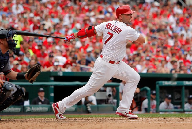 Jul 26, 2015; St. Louis, MO, USA; St. Louis Cardinals left fielder Matt Holliday (7) follows through on a RBI double during the fifth inning against the Atlanta Braves at Busch Stadium. The Braves won 3-2.  Mandatory Credit: Scott Kane-USA TODAY Sports