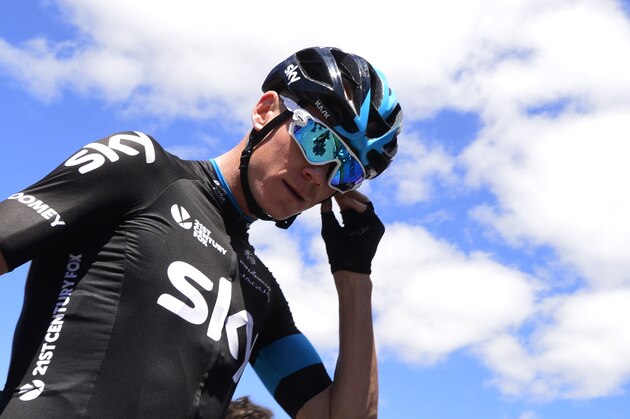 Sky's British cyclist Christopher Froome stands the third stage of the 2015 Vuelta Espana cycling tour, a 158.4km stage between Mijas and Malaga on August 24, 2015.  AFP PHOTO/JOSE JORDAN        (Photo credit should read JOSE JORDAN/AFP/Getty Images)