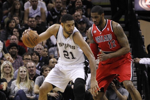 SAN ANTONIO, TX - MAY 14: Tim Duncan #21 of the San Antonio Spurs moves with the ball against LaMarcus Aldridge #12 of the Portland Trail Blazers in Game Five of the Western Conference Semifinals during the 2014 NBA Playoffs at the AT&T Center on May 14, 2014 in San Antonio, Texas. NOTE TO USER: User expressly acknowledges and agrees that, by downloading and/or using this photograph, user is consenting to the terms and conditions of the Getty Images License Agreement. (Photo by Chris Covatta/Getty Images)