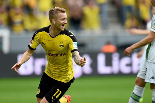 Dortmund's striker Marco Reus celebrates scoring during the German first division Bundesliga football match Borussia Dortmund vs Borussia Moenchengladbach in Dortmund, western Germany, on August 15, 2015.  AFP PHOTO / PATRIK STOLLARZ

RESTRICTIONS: DURING MATCH TIME: DFL RULES TO LIMIT THE ONLINE USAGE TO 15 PICTURES PER MATCH AND FORBID IMAGE SEQUENCES TO SIMULATE VIDEO. 
== RESTRICTED TO EDITORIAL USE ==
FOR FURTHER QUERIES PLEASE CONTACT DFL DIRECTLY AT + 49 69 650050.        (Photo credit should read PATRIK STOLLARZ/AFP/Getty Images)