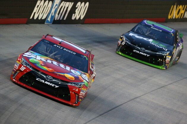BRISTOL, TN - AUGUST 22: Kyle Busch, driver of the #18 Skittles Toyota, leads Denny Hamlin, driver of the #11 FedEx Ground Toyota, during the NASCAR Sprint Cup Series IRWIN Tools Night Race at Bristol Motor Speedway on August 22, 2015 in Bristol, Tennessee.  (Photo by Brian Lawdermilk/Getty Images)