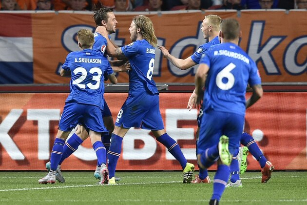 Iceland's midfielder Gylfi Thor Sigurdsson (2nd L) celebrates after scoring a penalty kick   during   the UEFA Euro 2016 qualifying round football match between Netherlands and Iceland at the Arena Stadium, on September 3, 2015 in Amsterdam. AFP PHOTO / JOHN THYS        (Photo credit should read JOHN THYS/AFP/Getty Images)