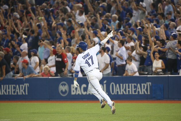 TORONTO, CANADA - SEPTEMBER 1: Ryan Goins #17 of the Toronto Blue Jays celebrates as he hits a game-winning two-run home run in the tenth inning during MLB game action against the Cleveland Indians on September 1, 2015 at Rogers Centre in Toronto, Ontario, Canada. (Photo by Tom Szczerbowski/Getty Images) TORONTO, CANADA - SEPTEMBER 1: Ryan Goins #17 of the Toronto Blue Jays celebrates as he hits a game-winning two-run home run in the tenth inning during MLB game action against the Cleveland Indians on September 1, 2015 at Rogers Centre in Toronto, Ontario, Canada. (Photo by Tom Szczerbowski/Getty Images)