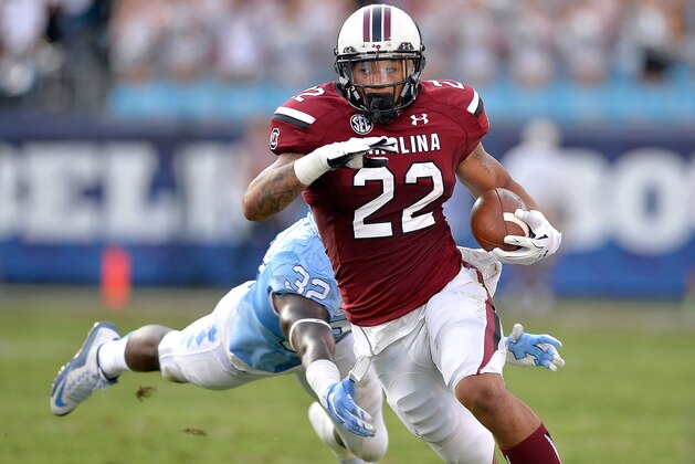CHARLOTTE, NC - SEPTEMBER 03: Brandon Wilds #22 of the South Carolina Gamecocks breaks away from Joe Jackson #32 of the North Carolina Tar Heels during their game at Bank of America Stadium on September 3, 2015 in Charlotte, North Carolina.  (Photo by Grant Halverson/Getty Images)