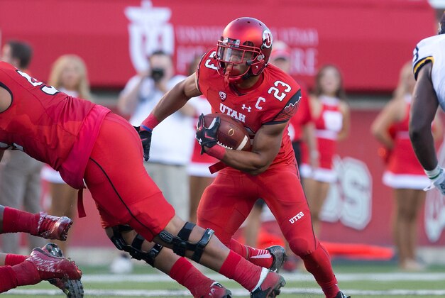 Sep 3, 2015; Salt Lake City, UT, USA; Utah Utes running back Devontae Booker (23) carries the ball during the first half against the Michigan Wolverines at Rice-Eccles Stadium. Mandatory Credit: Russ Isabella-USA TODAY Sports