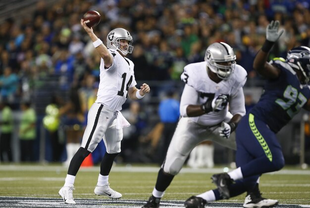Sep 3, 2015; Seattle, WA, USA; Oakland Raiders quarterback Matt McGloin (14) passes against the Seattle Seahawks during the second quarter at CenturyLink Field. Mandatory Credit: Joe Nicholson-USA TODAY Sports