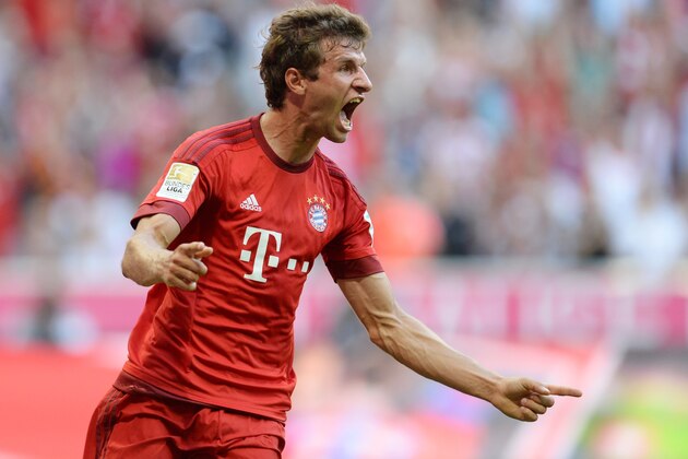Bayern Munich's striker Thomas Mueller celebrates after scoring the first goal for Munich during the German first division Bundesliga football match Bayern Munich vs Bayer 04 Leverkusen in Munich, southern Germany, on August 29, 2015.  AFP PHOTO / CHRISTOF STACHE

RESTRICTIONS: DURING MATCH TIME: DFL RULES TO LIMIT THE ONLINE USAGE TO 15 PICTURES PER MATCH AND FORBID IMAGE SEQUENCES TO SIMULATE VIDEO. 
== RESTRICTED TO EDITORIAL USE ==
FOR FURTHER QUERIES PLEASE CONTACT DFL DIRECTLY AT + 49 69 650050.        (Photo credit should read CHRISTOF STACHE/AFP/Getty Images)