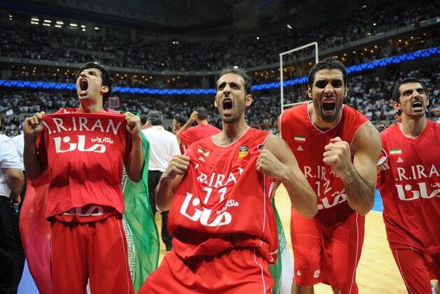 Iranian players celebrate after defeating the Philippines in the men's Asia championship basketball final game in Manila on August 11, 2013. Iran routed the Philippines 85-71 to bag gold at the 27th FIBA Asian men's basketball championship on August 11.   AFP PHOTO/TED ALJIBE        (Photo credit should read TED ALJIBE/AFP/Getty Images)