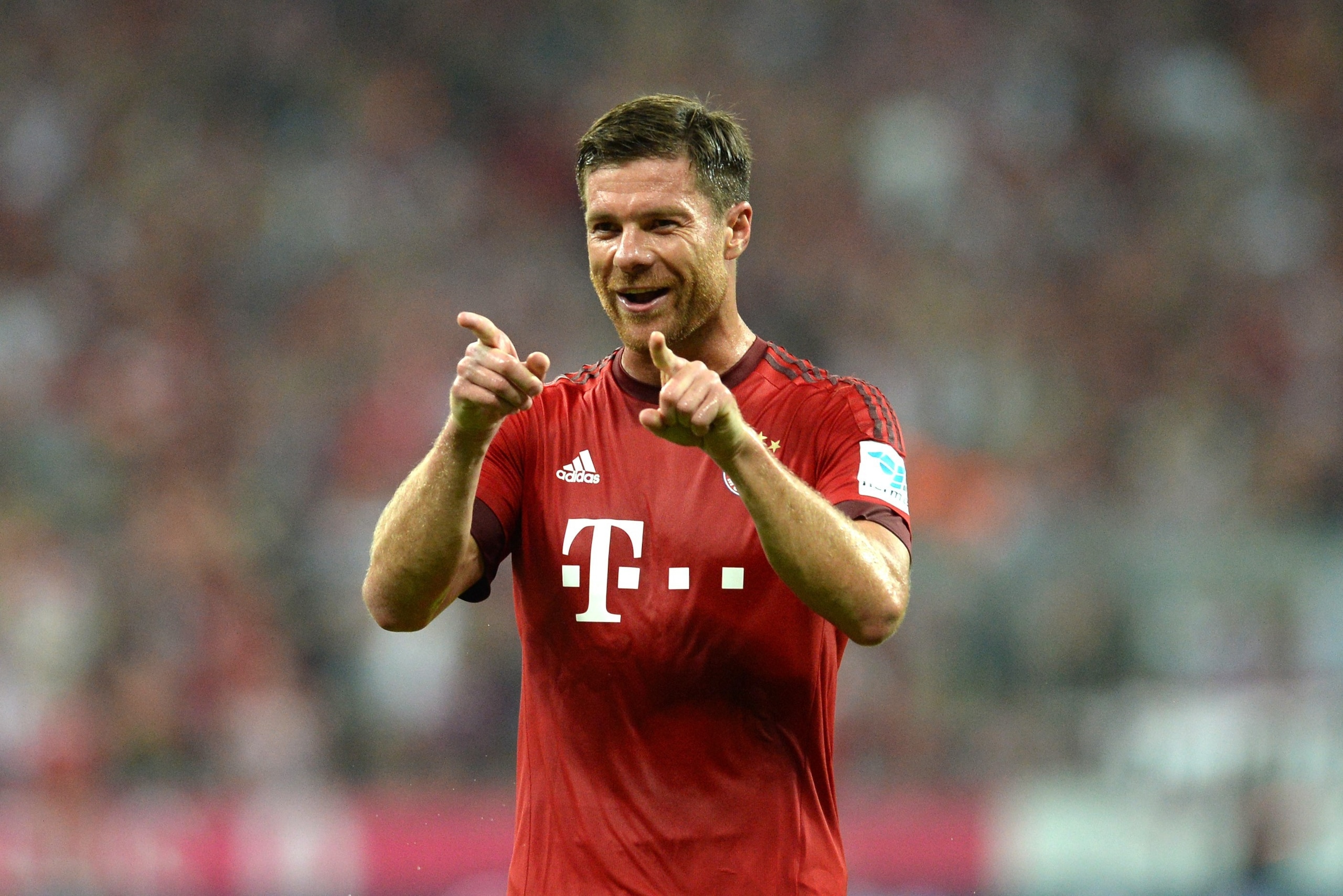 Bayern Munich's Spanish midfielder Xabi Alonso gestures during the German first division Bundesliga football match FC Bayern Munich vs Hamburger SV at the Allianz Arena in Munich, southern Germany, on August 14, 2015. The match was the first of the 2015/2016 season. Bayern Munich won the match 5-0. AFP PHOTO / CHRISTOF STACHE

RESTRICTIONS: DURING MATCH TIME: DFL RULES TO LIMIT THE ONLINE USAGE TO 15 PICTURES PER MATCH AND FORBID IMAGE SEQUENCES TO SIMULATE VIDEO. 
== RESTRICTED TO EDITORIAL USE ==
FOR FURTHER QUERIES PLEASE CONTACT DFL DIRECTLY AT + 49 69 650050.        (Photo credit should read CHRISTOF STACHE/AFP/Getty Images)
