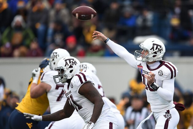 MEMPHIS, TN - DECEMBER 29:  Kyle Allen #10 of the Texas A&M Aggies throws a pass against the West Virginia Mountaineers during the 56th annual Autozone Liberty Bowl at Liberty Bowl Memorial Stadium on December 29, 2014 in Memphis, Tennessee.  Texas A&M won the game 45-37.  (Photo by Stacy Revere/Getty Images)