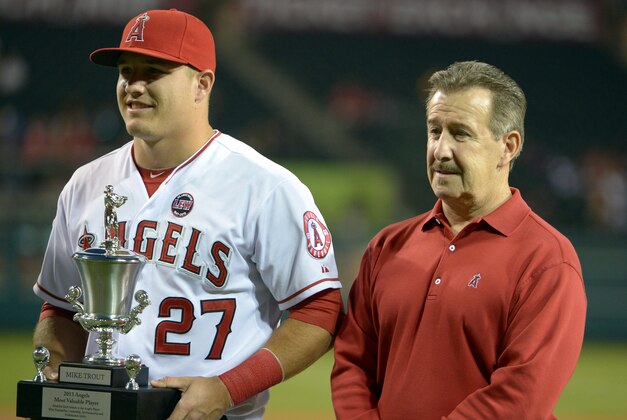 Sep 24, 2013; Anaheim, CA, USA; Los Angeles Angels designated hitter Mike Trout (27) poses with owner Arte Moreno after receiving the Angels most valuable player trophy before the game against the Oakland Athletics at Angel Stadium of Anaheim. Mandatory Credit: Kirby Lee-USA TODAY Sports