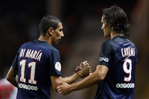 Paris Saint-Germain's Uruguayan forward Edinson Cavani (R) is congratulated by Paris Saint-Germain's Argentinian forward Angel Di Maria (L) after scoring his second goal during the French L1 football match Monaco (ASM) vs Paris Saint-Germain (PSG), on August 30, 2015 at the Louis II stadium in Monaco. AFP PHOTO / VALERY HACHE        (Photo credit should read VALERY HACHE/AFP/Getty Images)