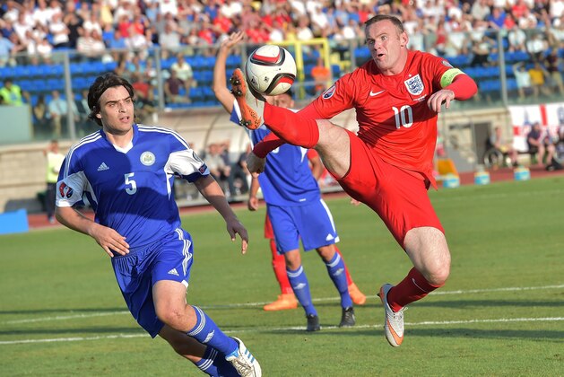 England's forward Wayne Rooney (R) controls the ball over San Marino's defender Davide Simoncini  during the EURO 2016 qualifying football match San Marino vs England at the San Marino stadium in Serravalle on September 5, 2015.  AFP PHOTO / VINCENZO PINTO        (Photo credit should read VINCENZO PINTO/AFP/Getty Images)