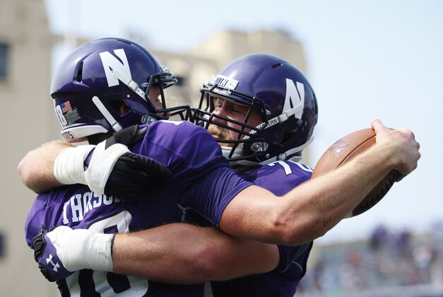 Sep 5, 2015; Evanston, IL, USA; Northwestern Wildcats quarterback Clayton Thorson (18) and Northwestern Wildcats offensive lineman Eric Olson (76) celebrate after quarterback Clayton Thorson (18) scores a touchdown in the first half against the Stanford Cardinal at Ryan Field. Mandatory Credit: Caylor Arnold-USA TODAY Sports
