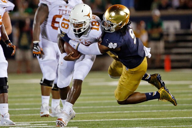 SOUTH BEND, IN - SEPTEMBER 05:  Jaylon Smith #9 of the Notre Dame Fighting Irish sacks Tyrone Swoopes #18 of the Texas Longhorns during the second quarter at Notre Dame Stadium on September 5, 2015 in South Bend, Indiana.  (Photo by Jon Durr/Getty Images)