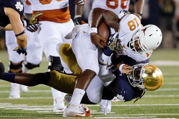 SOUTH BEND, IN - SEPTEMBER 05:  Jaylon Smith #9 of the Notre Dame Fighting Irish sacks Tyrone Swoopes #18 of the Texas Longhorns during the second quarter at Notre Dame Stadium on September 5, 2015 in South Bend, Indiana.  (Photo by Jon Durr/Getty Images)