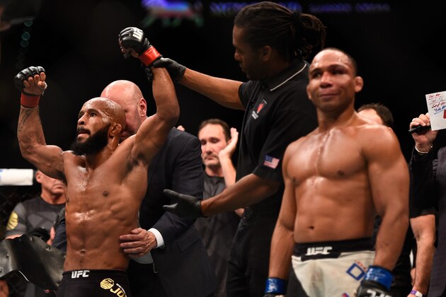 LAS VEGAS, NV - SEPTEMBER 05:  Demetrious Johnson (left) reacts to his victory over John Dodson (right) in their flyweight championship bout during the UFC 191 event inside MGM Grand Garden Arena on September 5, 2015 in Las Vegas, Nevada.  (Photo by Jeff Bottari/Zuffa LLC/Zuffa LLC via Getty Images)