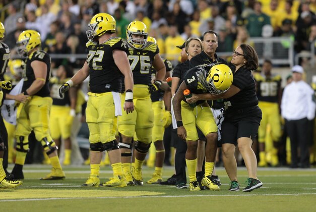 Sep 5, 2015; Eugene, OR, USA; Oregon Ducks quarterback Vernon Adams Jr. (3) is helped by the training staff following a late hit in the fourth quarter against the Eastern Washington Eagles at Autzen Stadium. Mandatory Credit: Scott Olmos-USA TODAY Sports