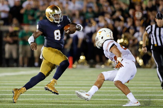 SOUTH BEND, IN - SEPTEMBER 05: Malik Zaire #8 of the Notre Dame Fighting Irish evades the tackle of John Bonney #24 of the Texas Longhorns during the second quarter at Notre Dame Stadium on September 5, 2015 in South Bend, Indiana. The Notre Dame Fighting Irish won 38-3.  (Photo by Jon Durr/Getty Images)
