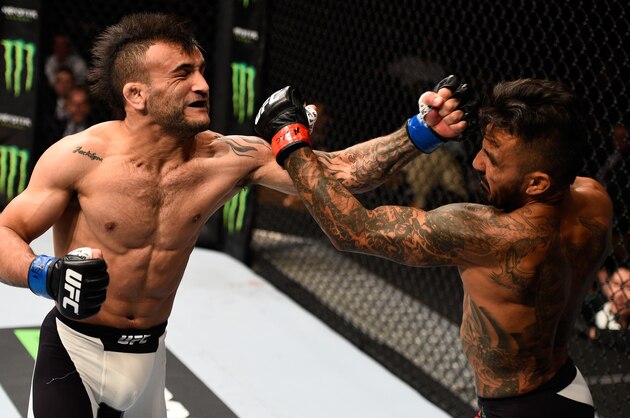 LAS VEGAS, NV - SEPTEMBER 05: (L-R) John Lineker and Francisco Rivera exchange punches in their bantamweight bout during the UFC 191 event inside MGM Grand Garden Arena on September 5, 2015 in Las Vegas, Nevada.  (Photo by Jeff Bottari/Zuffa LLC/Zuffa LLC via Getty Images)
