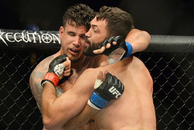Sep 5, 2015; Las Vegas, NV, USA; Frank Mir (blue gloves) and Andrei Arlovski (red gloves) during their heavyweight bout at UFC 191 at MGM Grand Garden Arena. Mandatory Credit: Jayne Kamin-Oncea-USA TODAY Sports