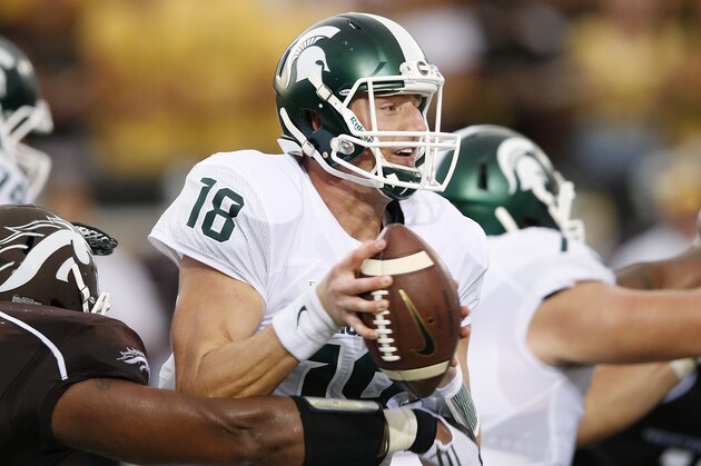 KALAMAZOO, MI - SEPTEMBER 4: Connor Cook #18 of the Michigan State Spartans is pressured by Nathan Braster #53 of the Western Michigan Broncos in the first half at Waldo Stadium on September 4, 2015 in Kalamazoo, Michigan. (Photo by Joe Robbins/Getty Images)