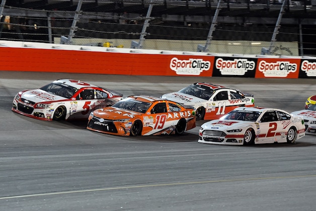 Sep 6, 2015; Darlington, SC, USA; NASCAR Sprint Cup Series drivers Kasey Kahne (5) and Carl Edwards (19) and  Brad Keselowski (2) race three wide during the Bojangles' Southern 500 at Darlington Raceway. Mandatory Credit: Jasen Vinlove-USA TODAY Sports