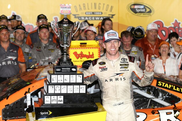 DARLINGTON, SC - SEPTEMBER 06:  Carl Edwards, driver of the #19 ARRIS Toyota, poses with the winner's trophy in Victory Lane after winning the NASCAR Sprint Cup Series Bojangles' Southern 500 at Darlington Raceway on September 6, 2015 in Darlington, South Carolina.  (Photo by Matt Hazlett/Getty Images)