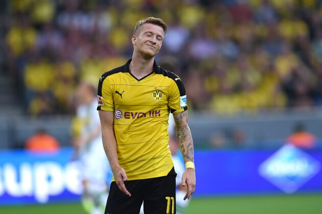 Dortmund's striker Marco Reus reacts during the German first division Bundesliga football match Borussia Dortmund vs Borussia Moenchengladbach in Dortmund, western Germany, on August 15, 2015.  AFP PHOTO / PATRIK STOLLARZ

RESTRICTIONS: DURING MATCH TIME: DFL RULES TO LIMIT THE ONLINE USAGE TO 15 PICTURES PER MATCH AND FORBID IMAGE SEQUENCES TO SIMULATE VIDEO. 
== RESTRICTED TO EDITORIAL USE ==
FOR FURTHER QUERIES PLEASE CONTACT DFL DIRECTLY AT + 49 69 650050.        (Photo credit should read PATRIK STOLLARZ/AFP/Getty Images)