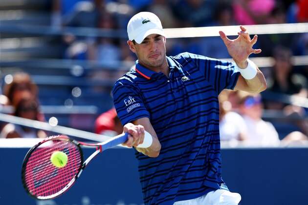 NEW YORK, NY - SEPTEMBER 05:  John Isner of the United States returns a shot against Jiri Vesely of the Czech Republic during their Men's Singles Third Round match on Day Six of the 2015 US Open at the USTA Billie Jean King National Tennis Center on September 5, 2015 in the Flushing neighborhood of the Queens borough of New York City.  (Photo by Clive Brunskill/Getty Images)