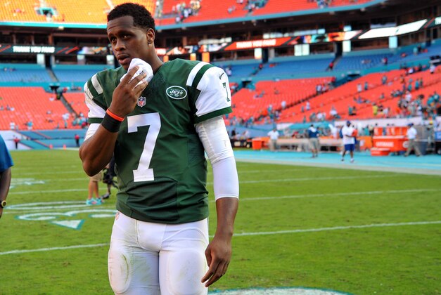 Dec 28, 2014; Miami Gardens, FL, USA; New York Jets quarterback Geno Smith (7) wipes his forehead after being interviewed against the Miami Dolphins at Sun Life Stadium. Mandatory Credit: Steve Mitchell-USA TODAY Sports