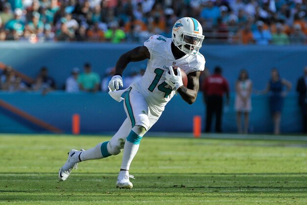 Dec 7, 2014; Miami Gardens, FL, USA; Miami Dolphins wide receiver Jarvis Landry (14) runs against the Baltimore Ravens during the second half at Sun Life Stadium. Ravens won 28-13.  Mandatory Credit: Steve Mitchell-USA TODAY Sports