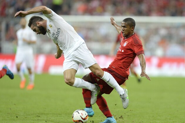 Bayern Munich's Brazilian midfielder Douglas Costa (R) and Real Madrid's defender Dani Carvajal vie for the ball during the Audi Cup final football match Real Madrid vs FC Bayern Munich in Munich, southern Germany, on August 5, 2015. AFP PHOTO / CHRISTOF STACHE (Photo credit should read CHRISTOF STACHE/AFP/Getty Images) Bayern Munich's Brazilian midfielder Douglas Costa (R) and Real Madrid's defender Dani Carvajal vie for the ball during the Audi Cup final football match Real Madrid vs FC Bayern Munich in Munich, southern Germany, on August 5, 2015. AFP PHOTO / CHRISTOF STACHE (Photo credit should read CHRISTOF STACHE/AFP/Getty Images)