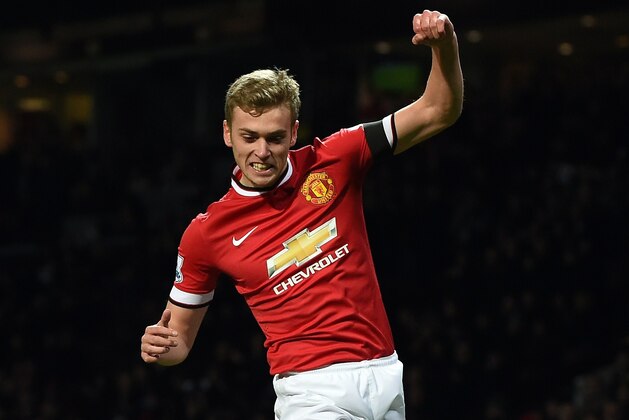 Manchester United's English striker James Wilson celebrates scoring their third goal during the FA Cup fourth round replay football match between Manchester United and Cambridge United at Old Trafford in Manchester, north west England, on February 3, 2015. AFP PHOTO / PAUL ELLIS 

== RESTRICTED TO EDITORIAL USE. No use with unauthorized audio, video, data, fixture lists, club/league logos or live services. Online in-match use limited to 45 images, no video emulation. No use in betting, games or single club/league/player publications.  ==        (Photo credit should read PAUL ELLIS/AFP/Getty Images)