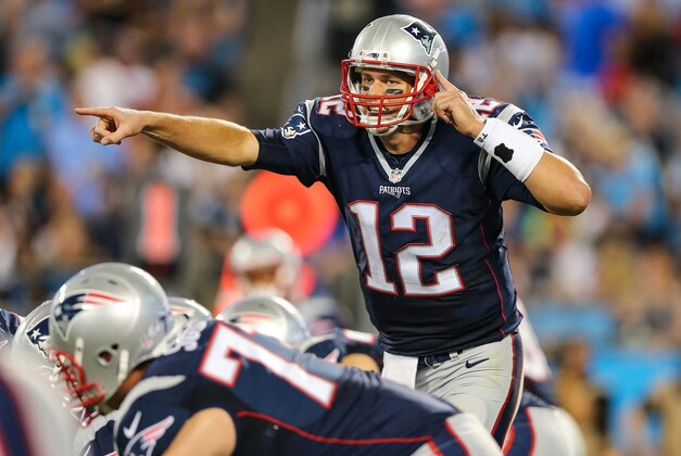 Aug 28, 2015; Charlotte, NC, USA; New England Patriots quarterback Tom Brady (12) points to the defense during the second quarter at Bank of America Stadium. Mandatory Credit: Jim Dedmon-USA TODAY Sports