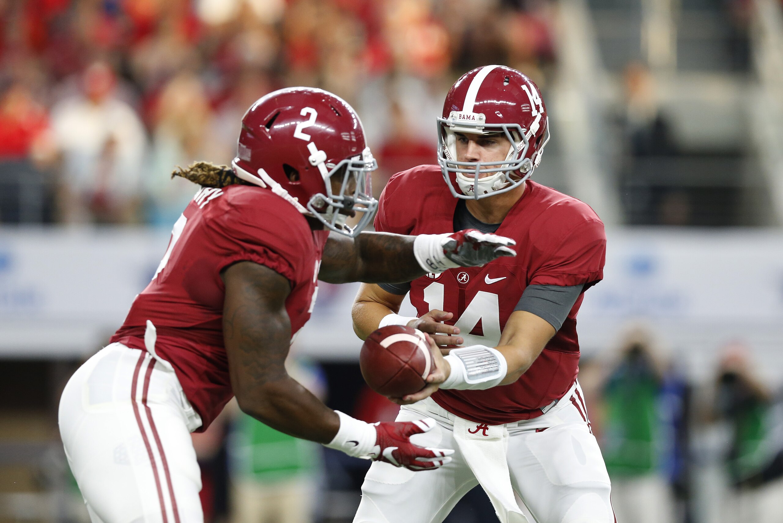 Sep 5, 2015; Arlington, TX, USA; Alabama Crimson Tide quarterback Jake Coker (14) hands off the ball to running back Derrick Henry (2) against the Wisconsin Badgers at AT&T Stadium. Mandatory Credit: Matthew Emmons-USA TODAY Sports