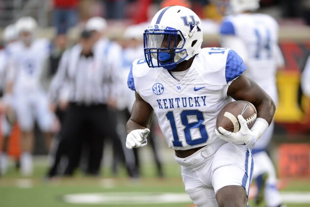 Nov 29, 2014; Louisville, KY, USA;  Kentucky Wildcats running back Stanley Williams (18) runs the ball against the Louisville Cardinals during the second half at Papa John's Cardinal Stadium. Louisville defeated Kentucky 44-40.  Mandatory Credit: Jamie Rhodes-USA TODAY Sports