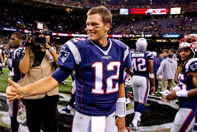 Aug 22, 2015; New Orleans, LA, USA; New England Patriots quarterback Tom Brady (12) gives a thumbs up to New Orleans Saints quarterback Drew Brees (not pictured) following a preseason game at the Mercedes-Benz Superdome. The Patriots defeated the Saints 26-24. Mandatory Credit: Derick E. Hingle-USA TODAY Sports